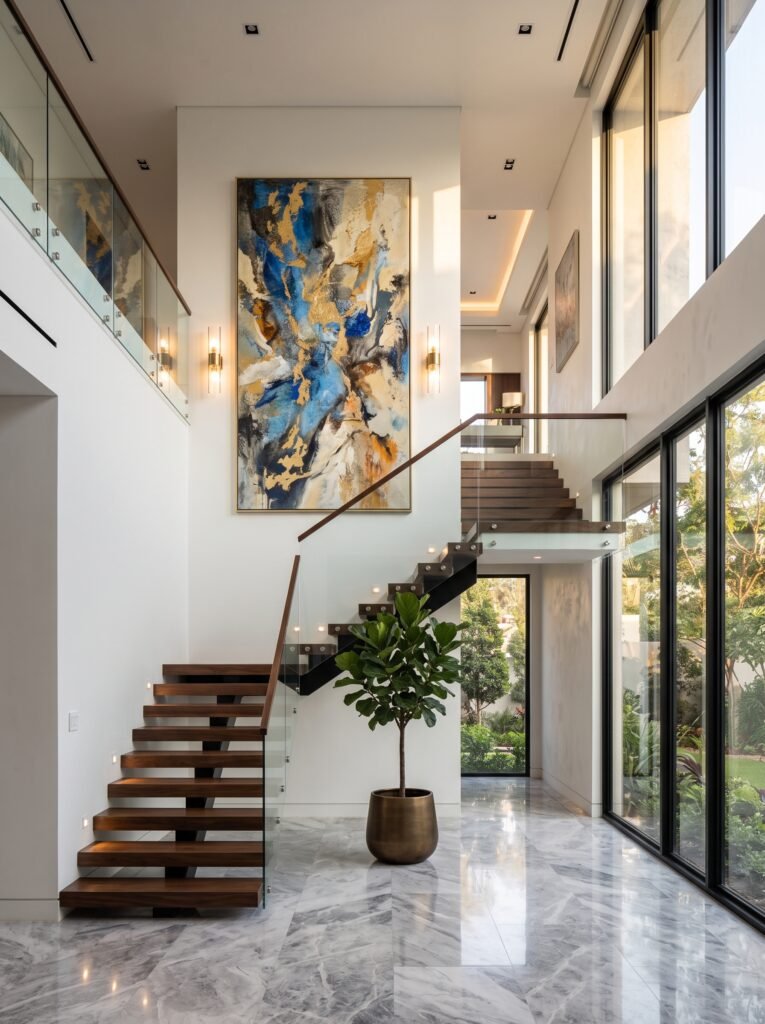Tall staircase wall decorated with oversized statement artwork