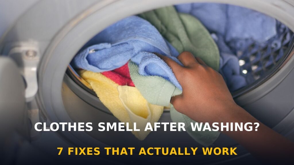 Hand loading colorful towels into a washing machine — why clothes smell after washing