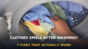Hand loading colorful towels into a washing machine — why clothes smell after washing