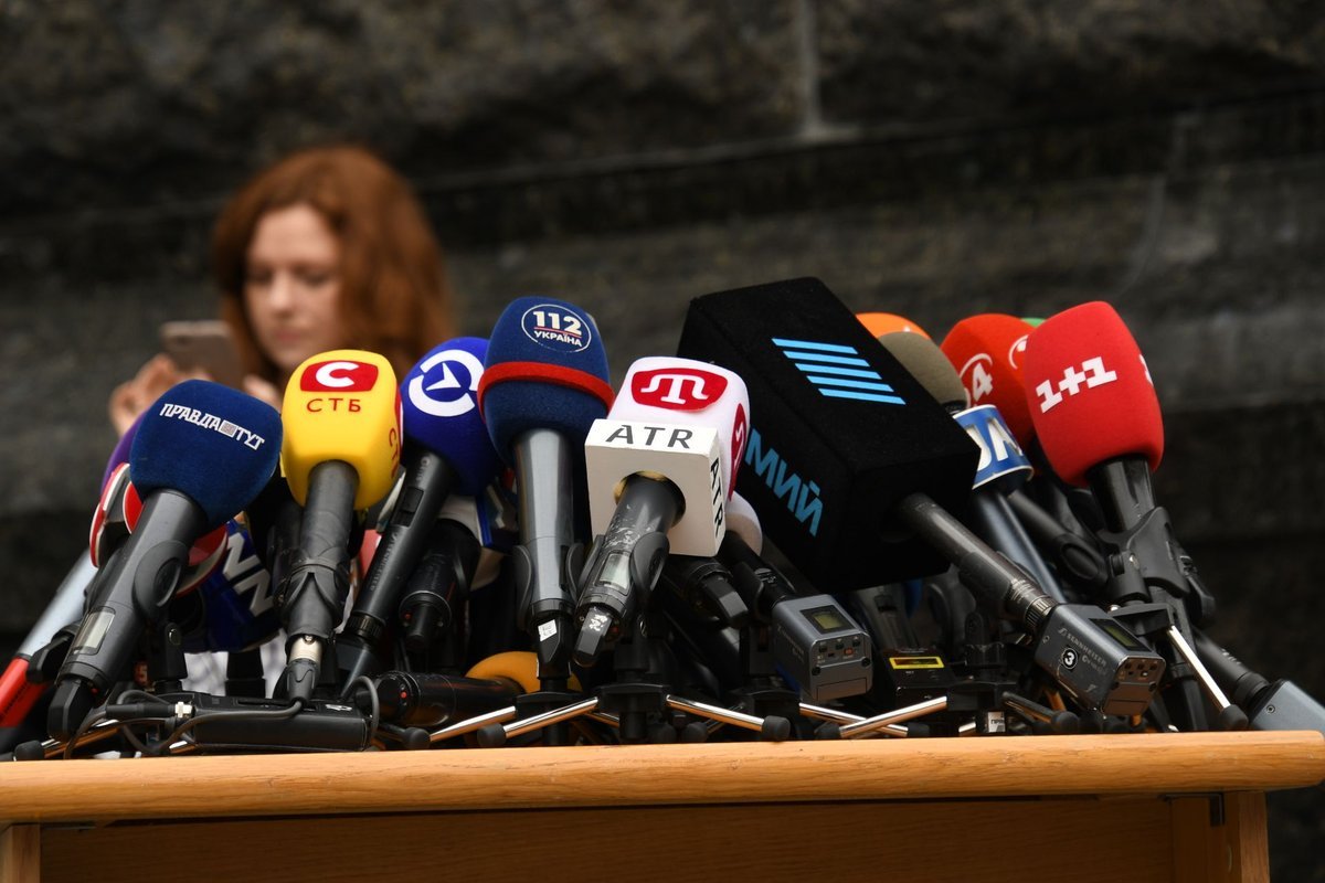 Press microphones at a news briefing — Katie Zacharia makes her debut as White House press secretary