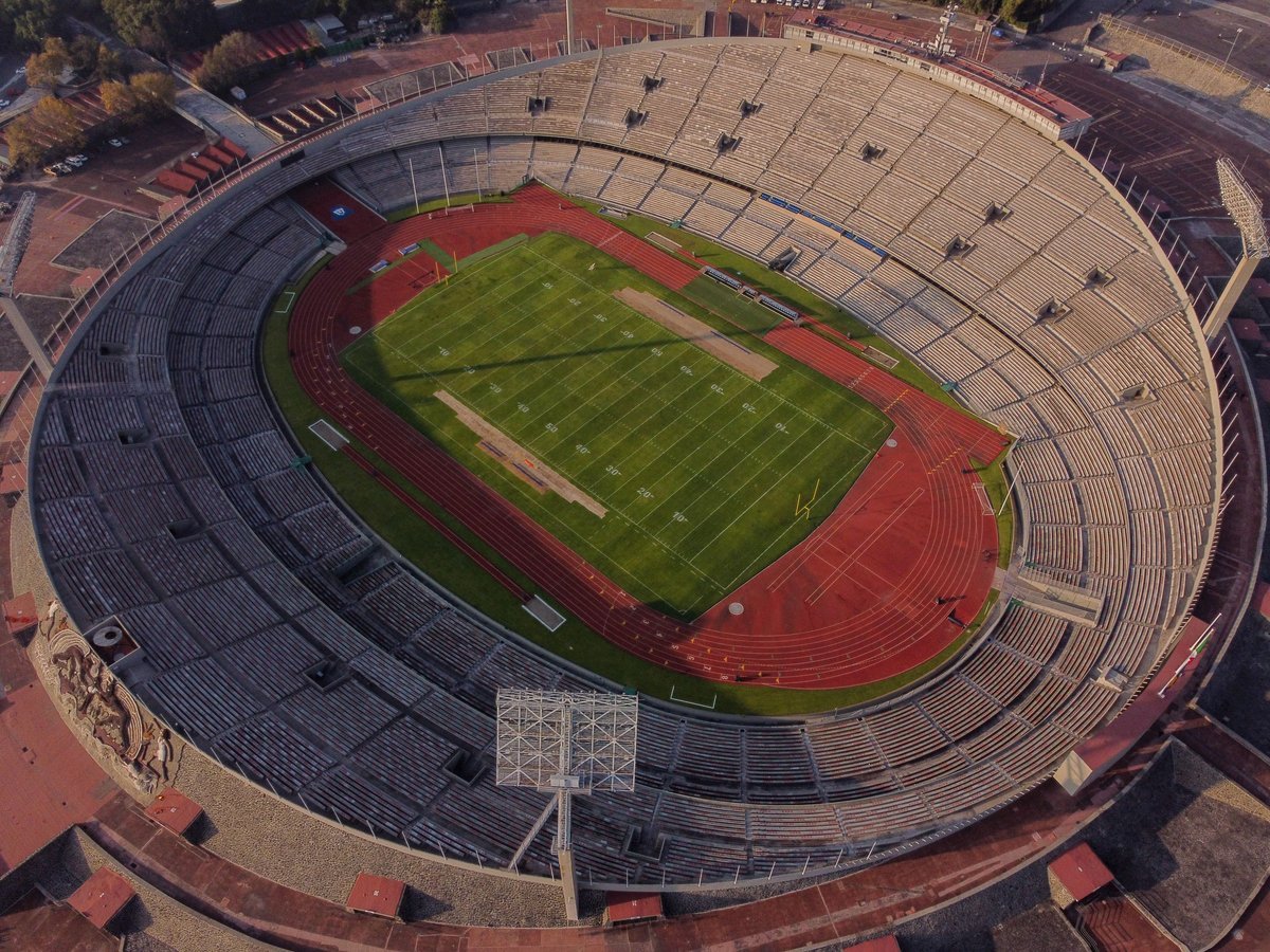 Aerial view of an empty American football stadium with yard lines and goalpost