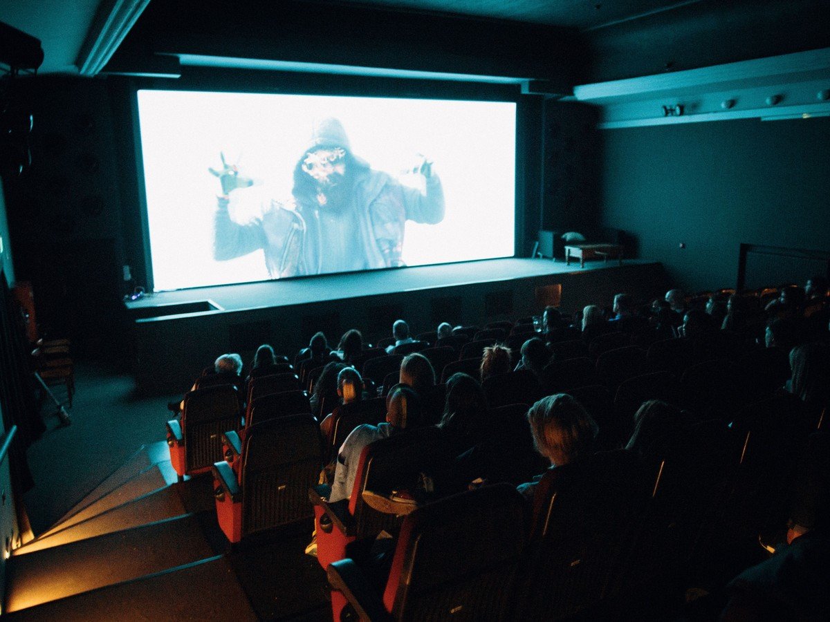 audience watching a film in a dark cinema — the Tom Cruise Digger flop left theaters empty
