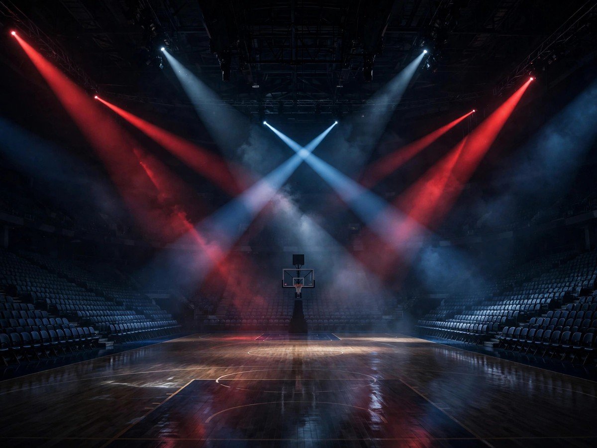 Dark basketball arena under spotlights during the Zion Williamson death hoax story.