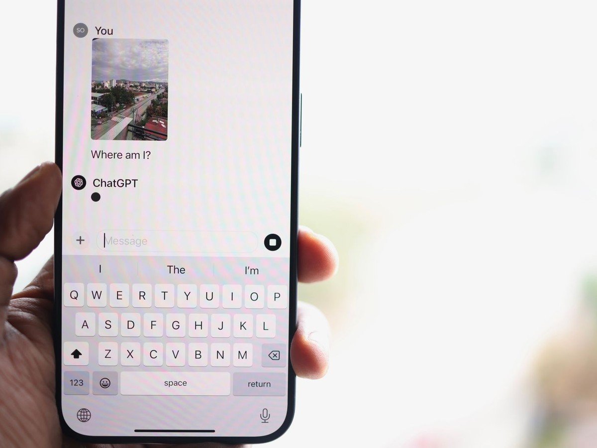 Person holding a phone showing the ChatGPT app while checking how to get ChatGPT Plus free