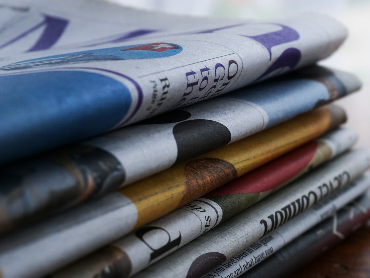 Stack of folded newspapers illustrating the NYT shareholders lawsuit story
