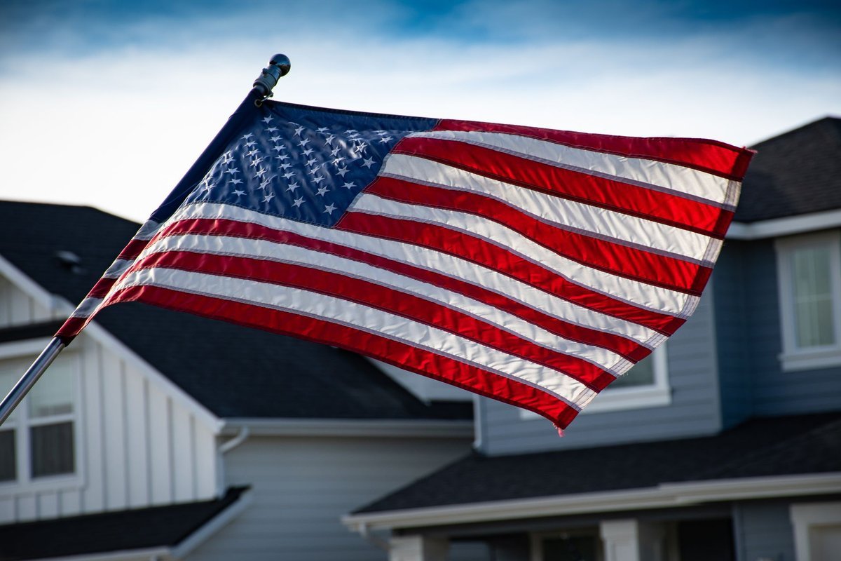 American flag — Zacharia takes the podium three weeks before the November midterm elections