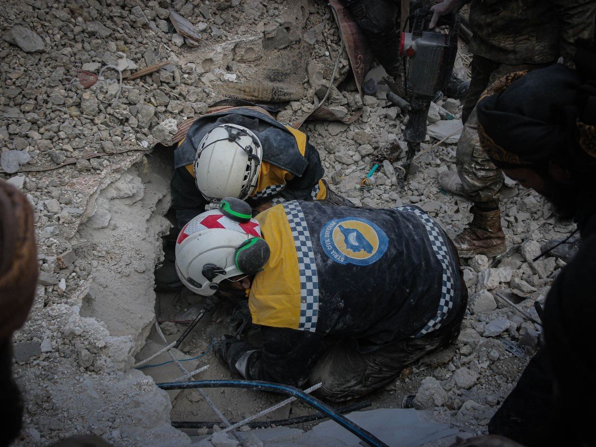 Rescue workers searching through rubble after a building collapse (illustrative photo)