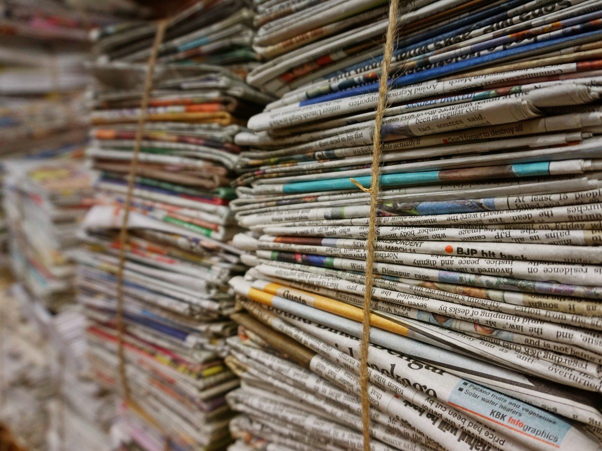 Bundles of newspapers stacked together — coverage of the New York Times lawsuit