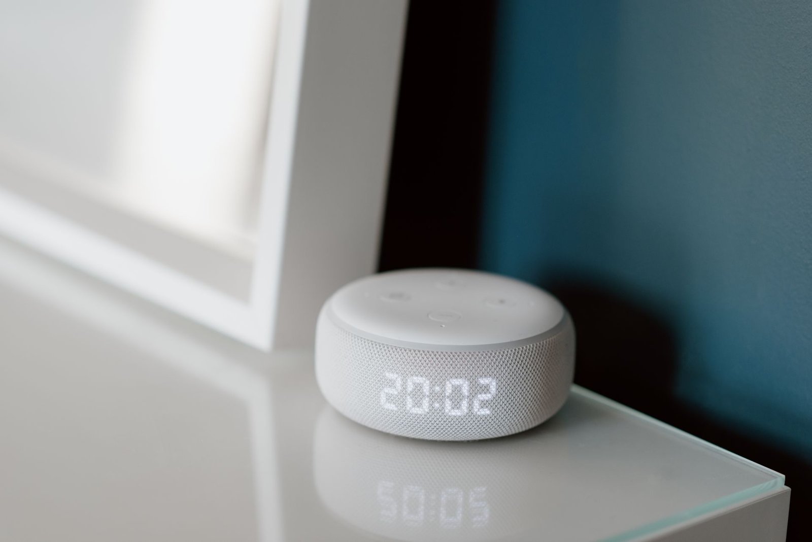 Smart speaker with digital clock display representing voice-assistant control on the Apple HomeView
