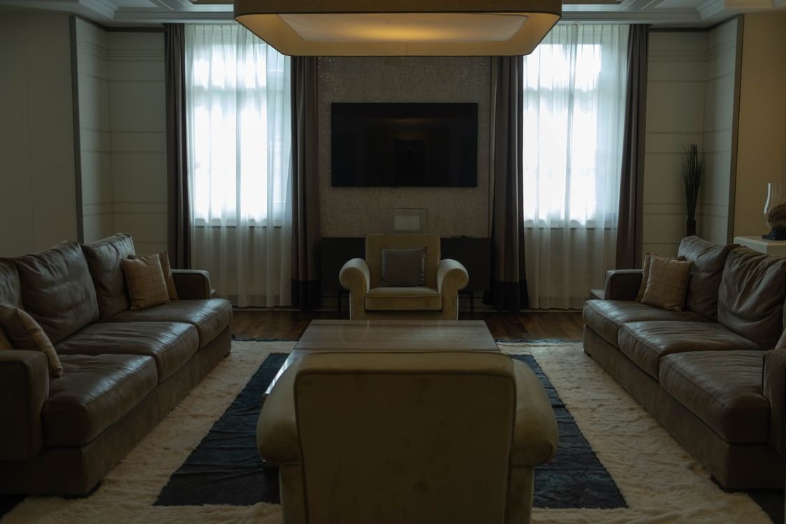 Furnished Atlanta condo living room with sofas and TV — Mia Thornton felony theft furniture case