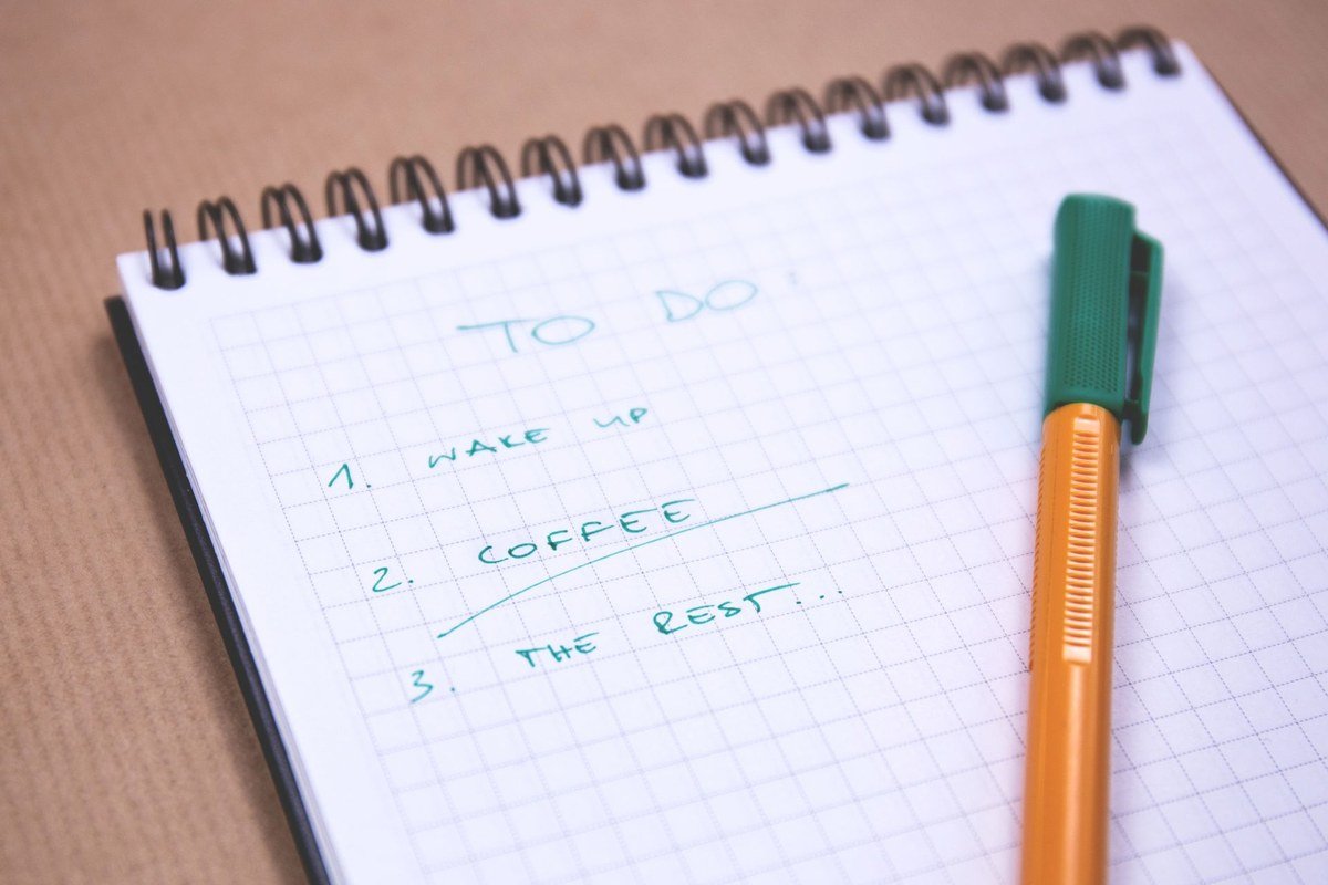 Handwritten to-do list in a notebook showing how to stop procrastinating with small tasks
